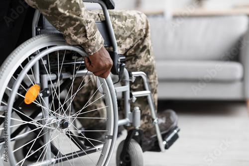 Photography Unrecognizable black soldier sitting in wheelchair, copy space