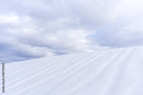 abstract picture of a hill full of snow with cloudy sky  © Sebastian