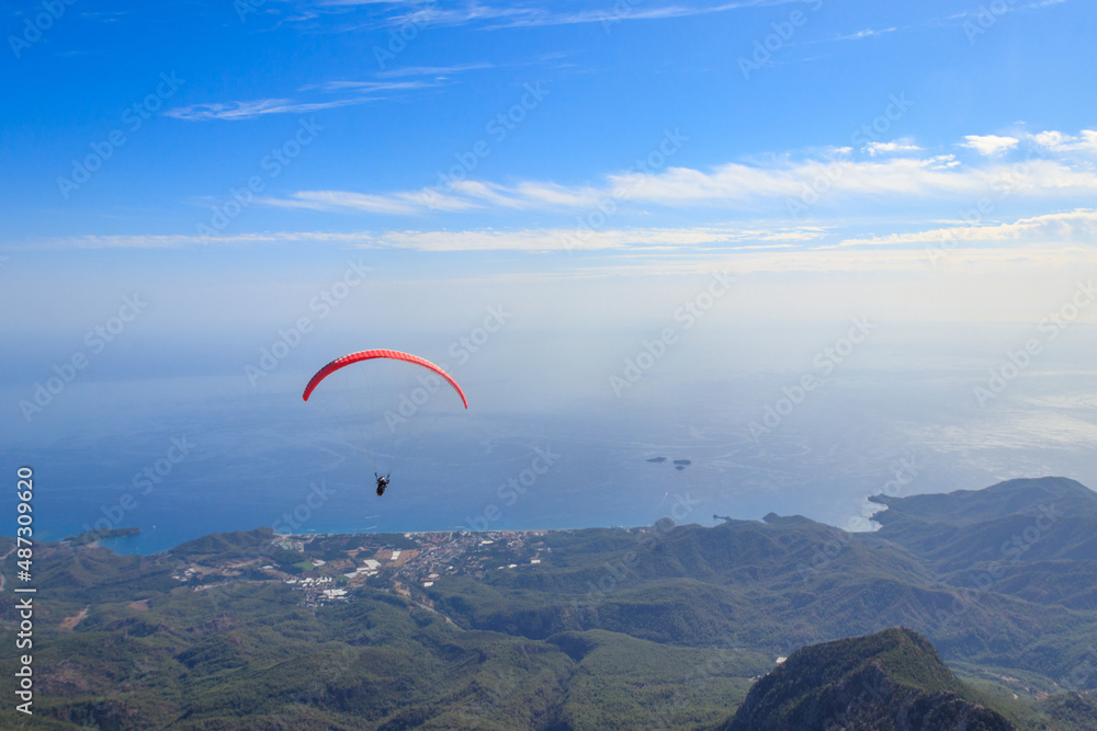 Paragliders flying from a top of Tahtali mountain near Kemer, Antalya Province in Turkey. Concept of active lifestyle and extreme sport adventure Paragliders flying from a top of Tahtali mountain near Kemer, Antalya Province in Turkey. Concept of active lifestyle and extreme sport adventure