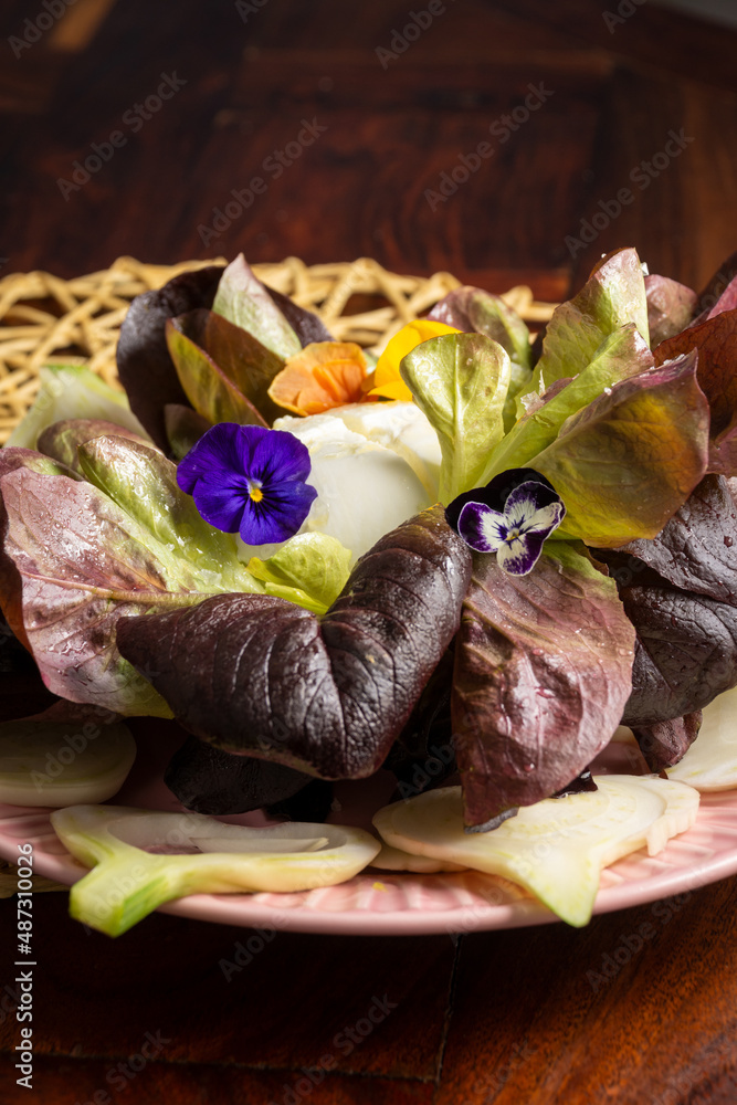 Top view of live lettuce salad with fennel, burrata and flowers on wooden table, vertical Top view of live lettuce salad with fennel, burrata and flowers on wooden table, vertical