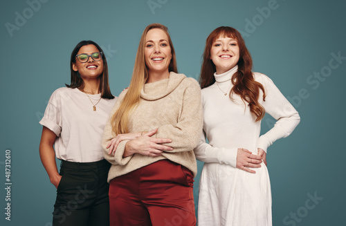 Smiling group of women looking at the camera in a studio photo