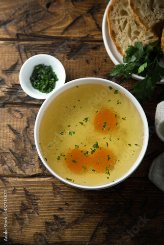 Traditional homemade chicken broth with vegetables