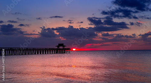 pier jetty at sunset in Naples, forida, usa photo