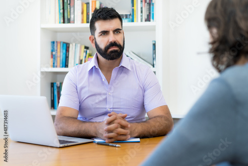 Serious businessman with beard in discussion at job interview