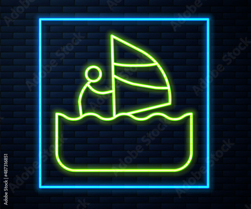 Glowing neon line Windsurfing icon isolated on brick wall background. Vector