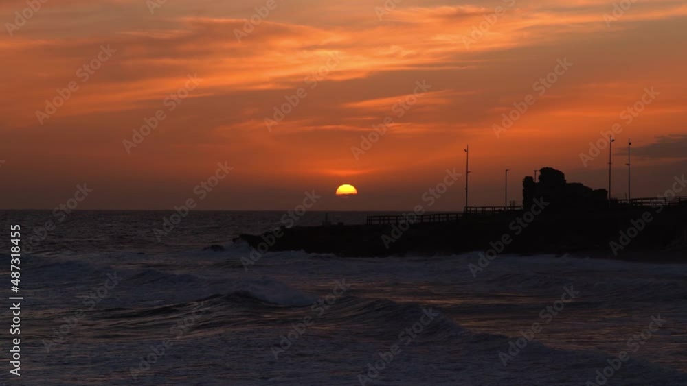 100 fps movie of beautiful sunset in Nerja City - Malaga - Costa del Sol. Beautiful orange colours at golden hour. In background 100 fps movie of beautiful sunset in Nerja City - Malaga - Costa del Sol. Beautiful orange colours at golden hour. In background