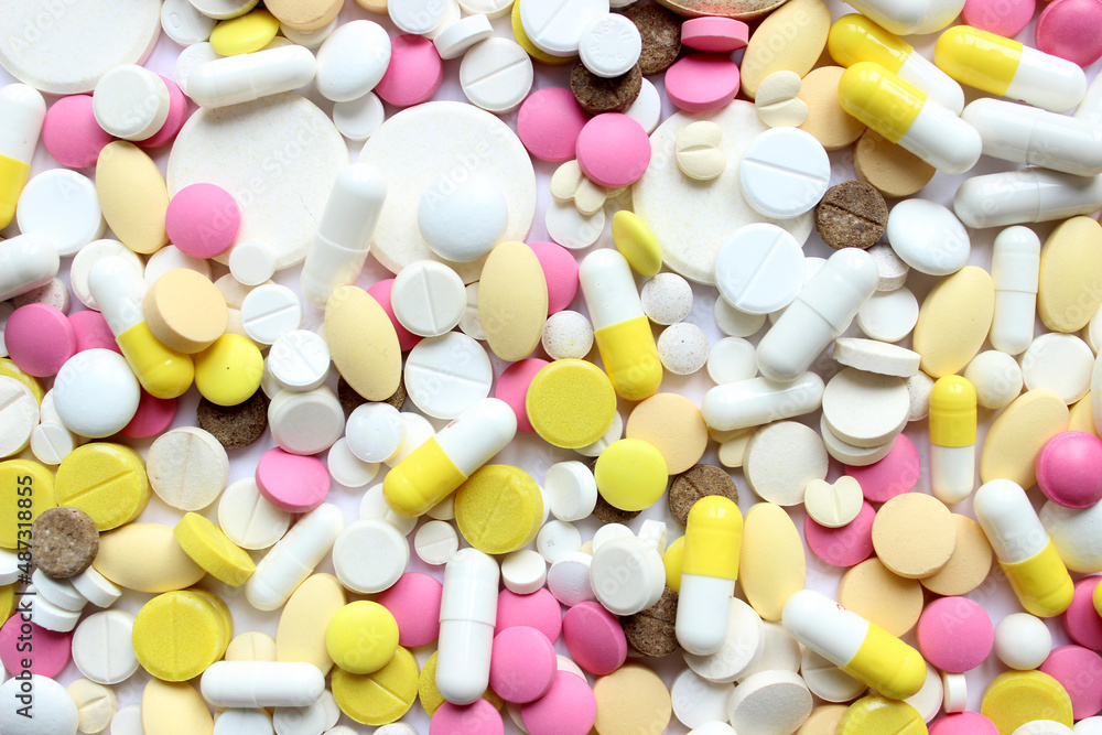 Different pills on color background, flat lay. Different pills on color background, flat lay.