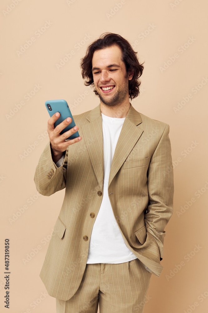 Cheerful man takes a selfie classic style technologies beige background Cheerful man takes a selfie classic style technologies beige background