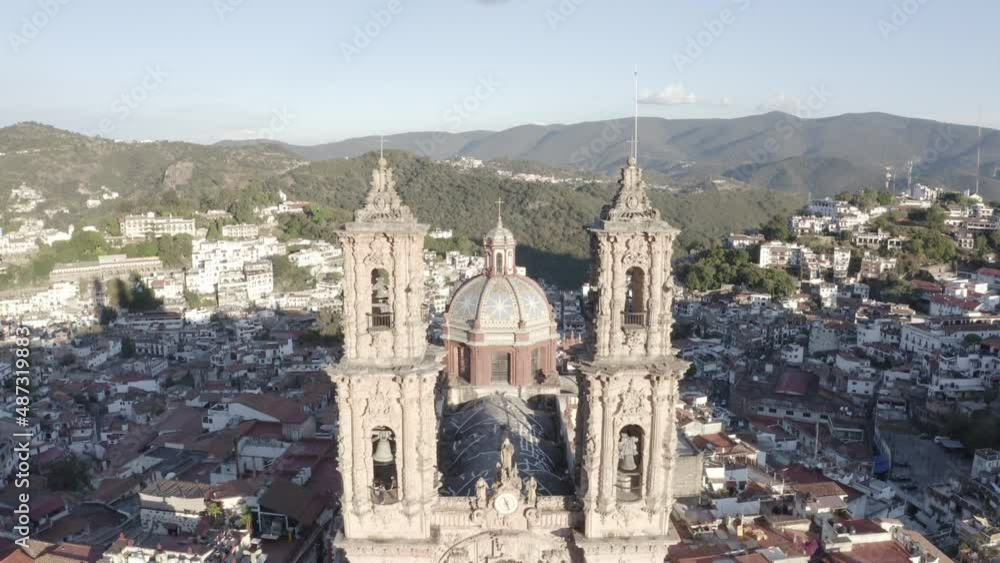 Aerial View of Santa Prisca Catholic Church in Taxco de Alarcon, Mexico, Flying Between Bell Towers and Cityscape on Sunny Day, Drone Shot Aerial View of Santa Prisca Catholic Church in Taxco de Alarcon, Mexico, Flying Between Bell Towers and Cityscape on Sunny Day, Drone Shot