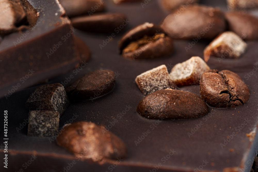 Close up of dark chocolate bar with coffee beans and candied fruit Close up of dark chocolate bar with coffee beans and candied fruit