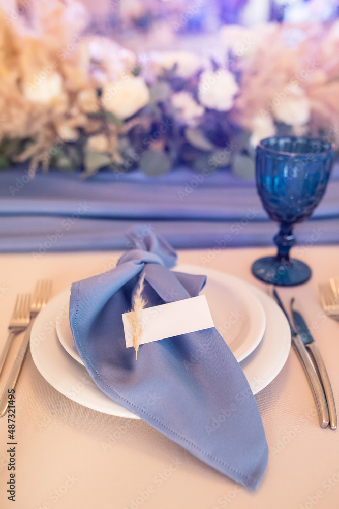 banquet table is decorated with plates, cutlery, glasses, candles and flower arrangements banquet table is decorated with plates, cutlery, glasses, candles and flower arrangements
