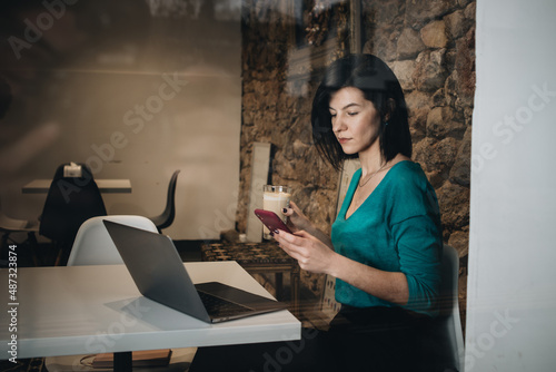 Businesswoman with laptop in cafe