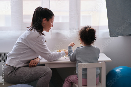 Mother and daughter having breakfast together at home. Mother's day concept