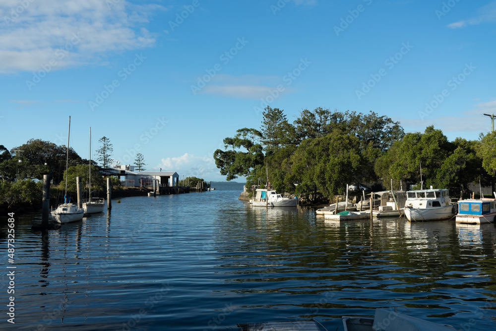 Little old boats moored in the tidal creek at Wynnum, Queensland, Australia. 