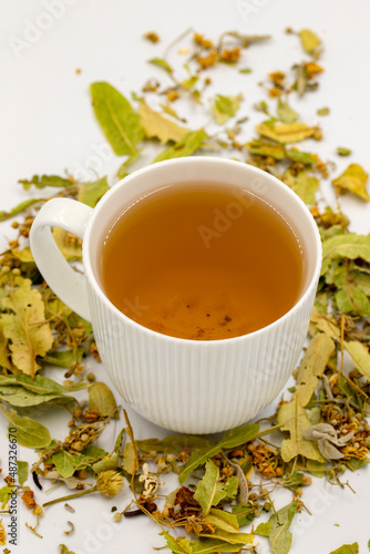 Winter Herbal tea isolated on a white background. Linden tea. immune-boosting herbal tea. Medicinal tea prepared from linden leaves, Clove particles and Chamomile.