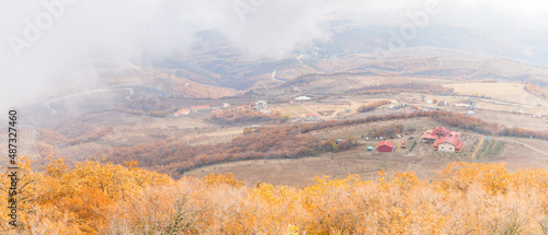 Panorama of the valley in the fog on the village of Luchistoe