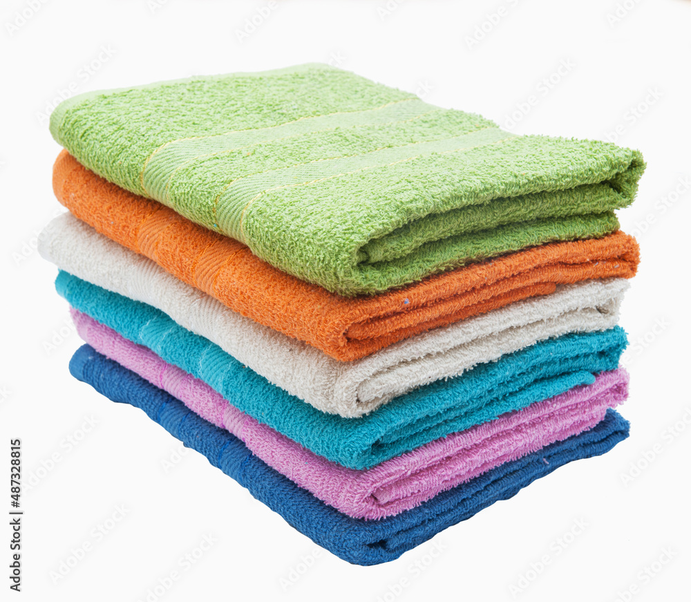 Stack of multi-colored terry towels on a white background Stack of multi-colored terry towels on a white background