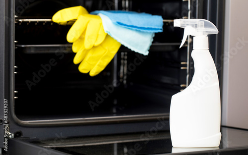 Wallpaper Mural On the door of an open oven is a mock-up of a white spray bottle with oven detergent. General cleaning of the kitchen. Torontodigital.ca