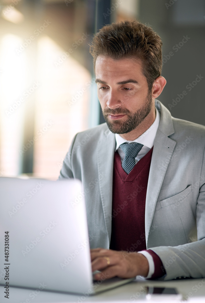 Hard work is how he makes success a reality. Shot of a businessman using a laptop at his office desk. Hard work is how he makes success a reality. Shot of a businessman using a laptop at his office desk.