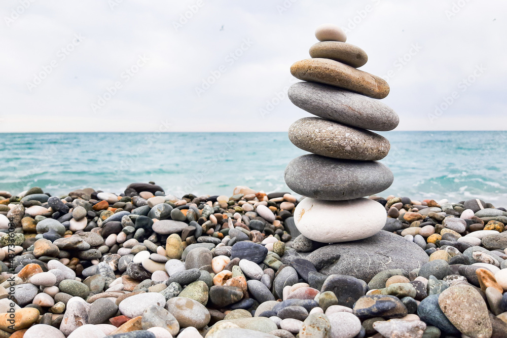 Pyramid stones balanced on the beach. The object is in focus, the background is blurred. Pyramid stones balanced on the beach. The object is in focus, the background is blurred.
