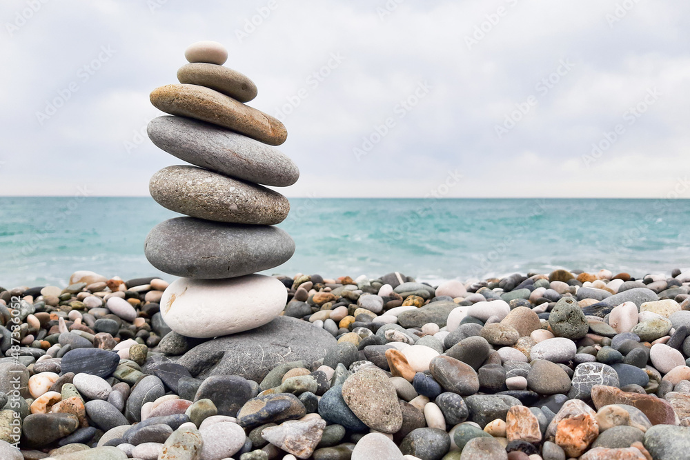 Pyramid stones balanced on the beach. The object is in focus, the background is blurred. Pyramid stones balanced on the beach. The object is in focus, the background is blurred.