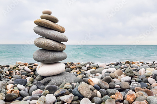 Pyramid stones balanced on the beach. The object is in focus  the background is blurred.