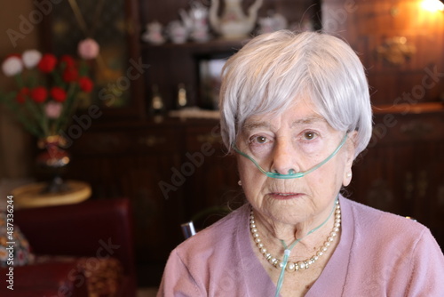 Quadro em tela Senior woman using nasal cannula due to lack of oxygen
