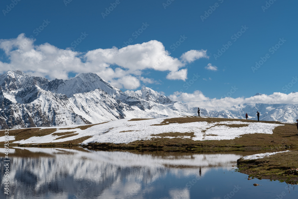 Incredibly beautiful mountain landscape: a lake in the snowy mountains, which reflects the snowy mountain peaks visible in the distance. Koruldi Lakes in Georgia