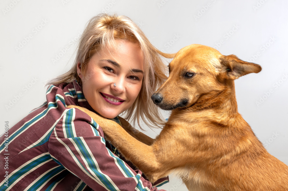 Young attractive woman embracing her dog. Pet care and animals concept
