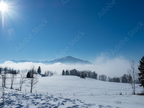 View from a snow covered meadow towards Rigi, a famous mountain in Switzerland