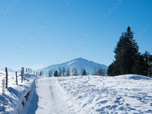 View towards mount Rigi, a famous peak in Switzerland, along a snow covered winter hiking trail. © Thomas