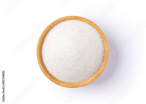 Monosodium glutamate (MSG) in wooden bowl isolated on white background. Top view.