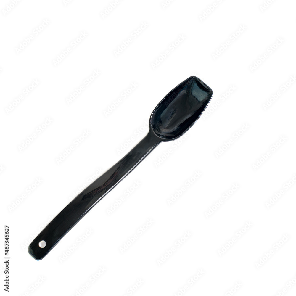 A black spoon for loose materials in the kitchen on an insulated white background.