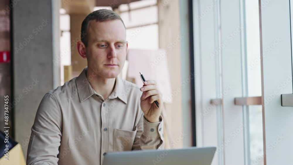 Focused man with concerned look stares at his laptop. Businessman becomes happy about the result and makes cheerful expression. Close up. Focused man with concerned look stares at his laptop. Businessman becomes happy about the result and makes cheerful expression. Close up.