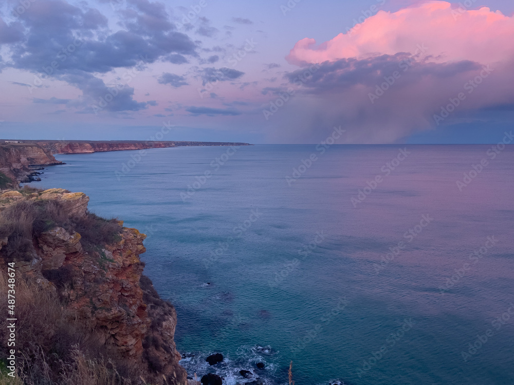 A large thundercloud on the horizon over the sea. A large thundercloud on the horizon over the sea.