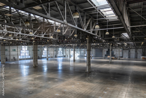Spacious empty pavilion for exhibitions and fairs. Hangar, a place intended for storage of large-sized objects. Modern large warehouse or storage photo