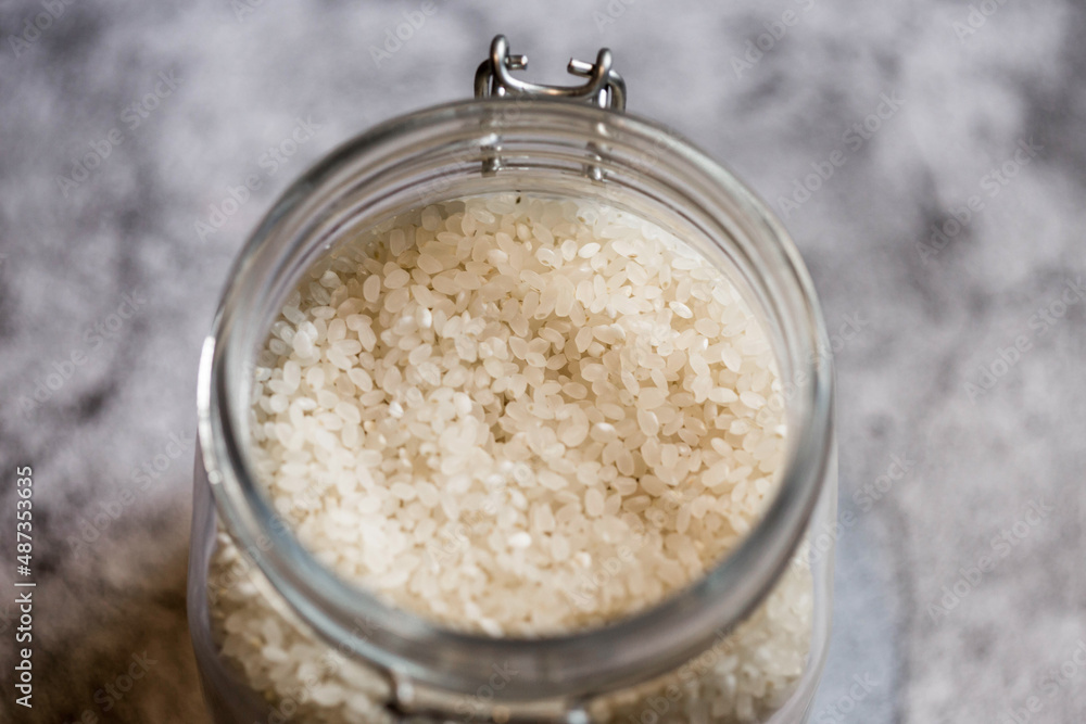 Glass jar with grains of rice, top view Glass jar with grains of rice, top view