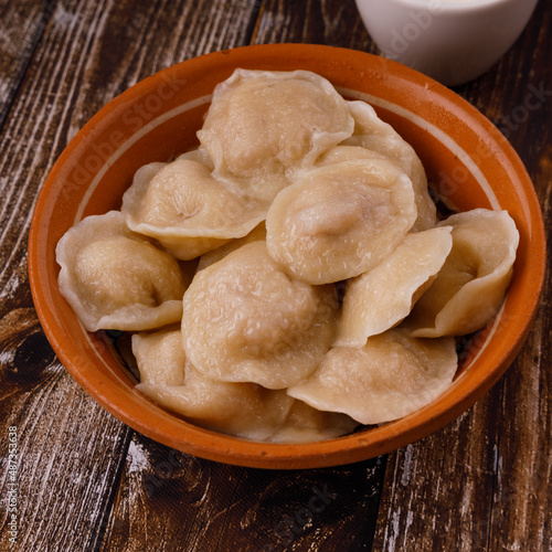 dumplings in clay plate on wooden background for restaurant menu1 photo