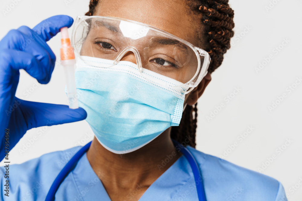 Black doctor wearing face mask posing with covid test Black doctor wearing face mask posing with covid test