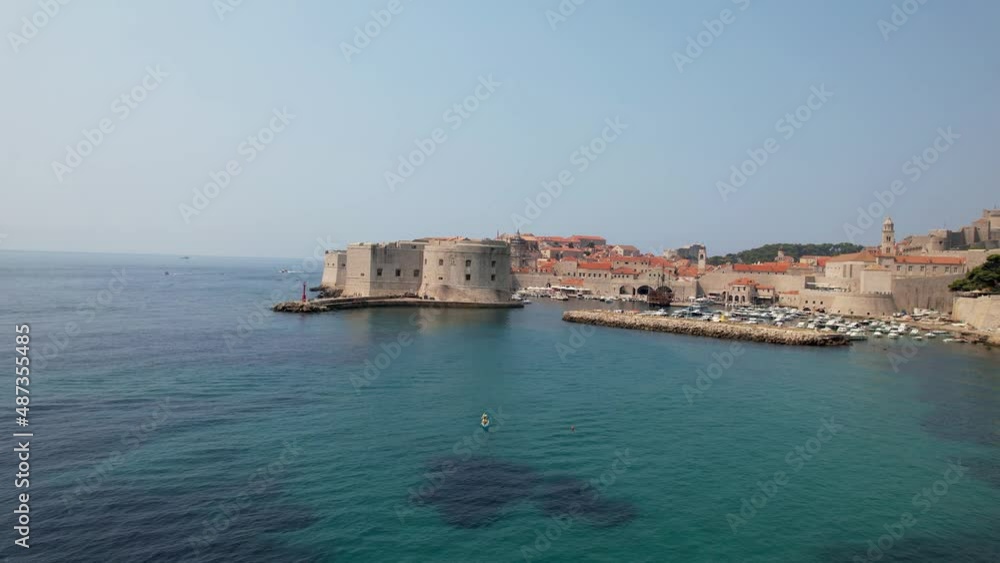 Aerial Approach and Rise Over Dark and Light Blue Turquoise Waters of Adriatic Sea to Medieval Terracotta Roof City of Dubrovnik Croatia Drone 4k Aerial Approach and Rise Over Dark and Light Blue Turquoise Waters of Adriatic Sea to Medieval Terracotta Roof City of Dubrovnik Croatia Drone 4k