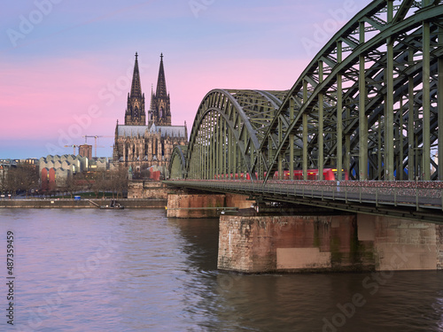 Morning view of the famous cathedral in the German city of Cologne and the Hohenzollern bridge over the river Rhine.