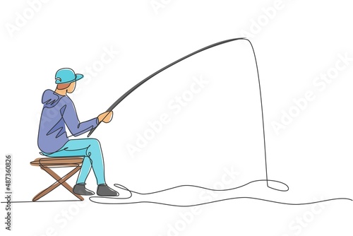 One single line drawing young happy fisher man siting relax and flyfishing at the riverside vector illustration graphic. Holiday traveling for fishing hobby concept. Modern continuous line draw design