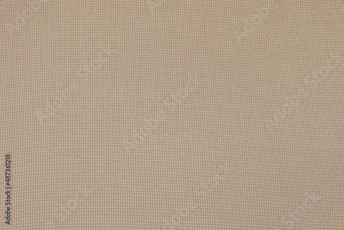 Flat khaki-colored fabric texture background. This fabric is made of cotton and polyester.