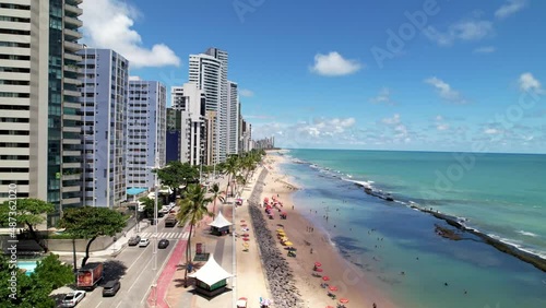 Aerial Slow Rise Above Vibrant Summer Beach and Street Shoreline of Tropical Coastal City Recife Brazil Turquoise Ocean Summer Day Drone 4k photo