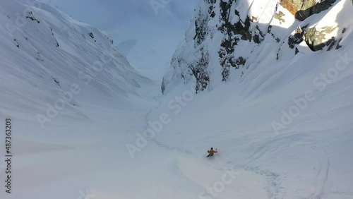 impressive footage of skier dropping down the mountain in the Canadian wilderness photo