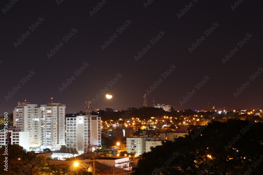 night view of the city with moon