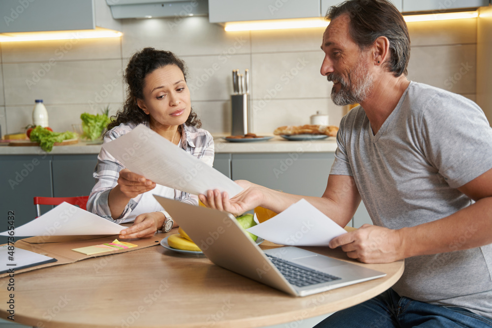 Man and woman working with official papers at home Man and woman working with official papers at home