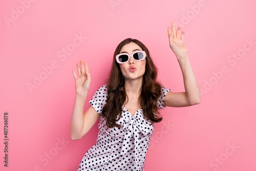 Photo of shiny sweet woman wear white dress dark glasses dancing sending kiss isolated pink color background