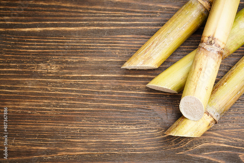 Close-up sugarcane on wooden background with space for text. Top view.