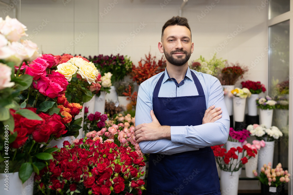 young florist Professional in the refrigerator with fresh flowers